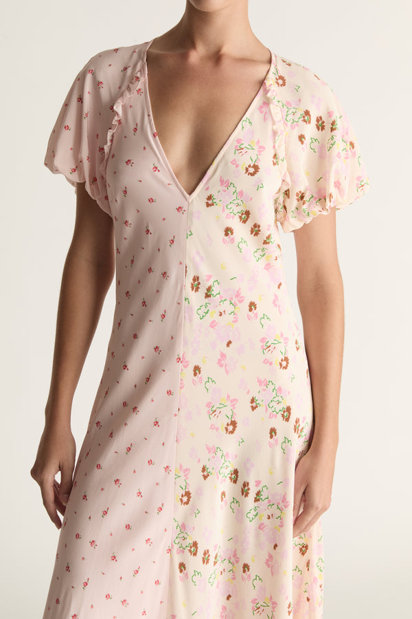 Woman wearing a floral dress with a plain background