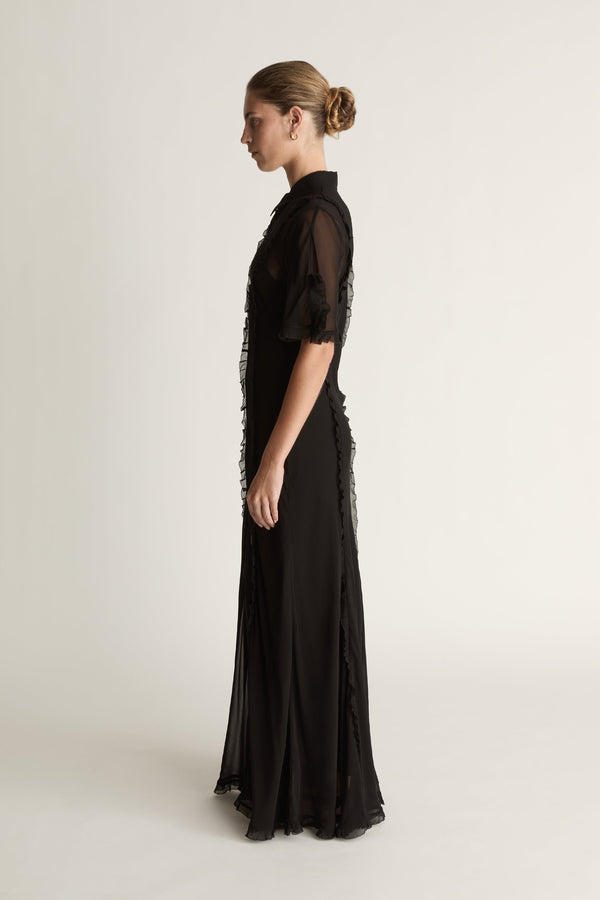 Black dress with sheer sleeves on a white background