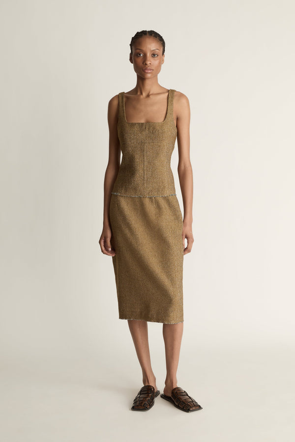 Woman facing the camera wearing a brown linen wool blend pencil-style skirt on a white background.