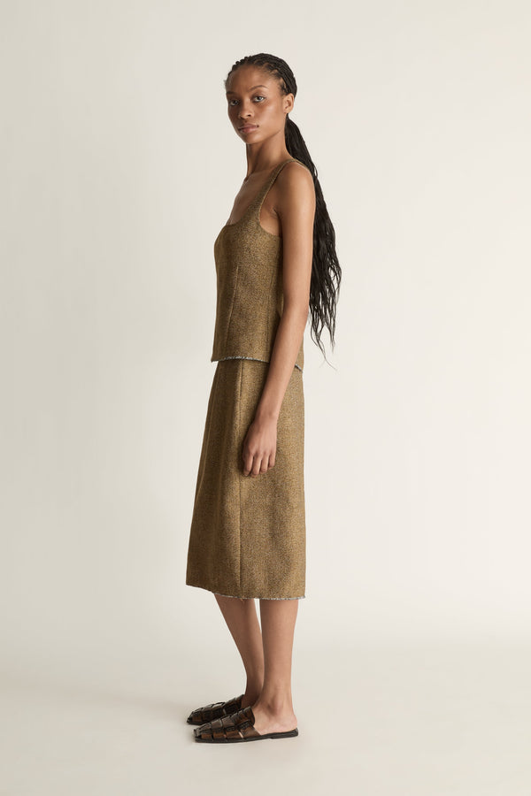 Side view of a woman wearing a brown linen wool pencil style skirt