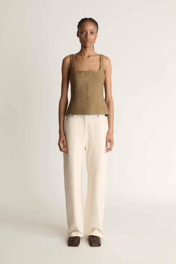 Front view image of a woman wearing a brown wool/linen blend tank top and ivory  straight leg jeans on a white background/ 