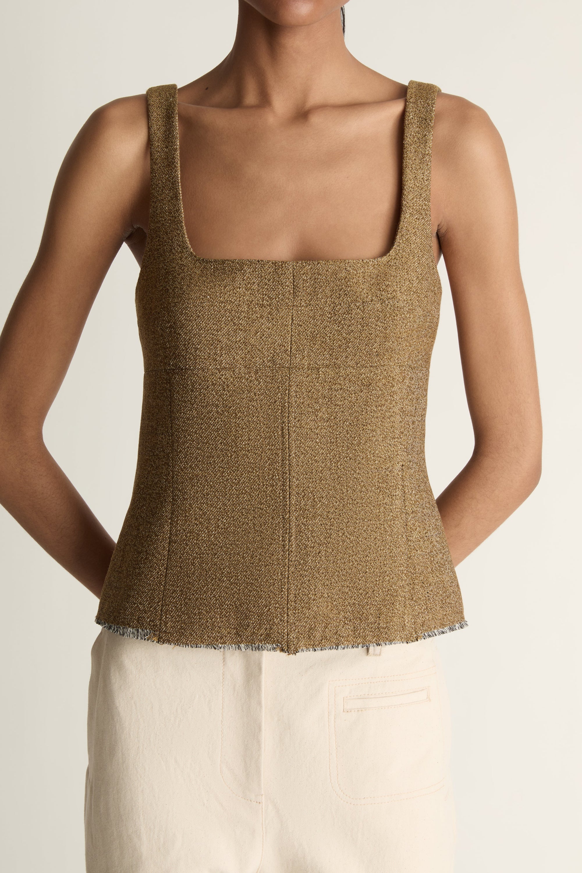 Close up image of a woman wearing the Esme top in a nutmeg brown colour on a white background
