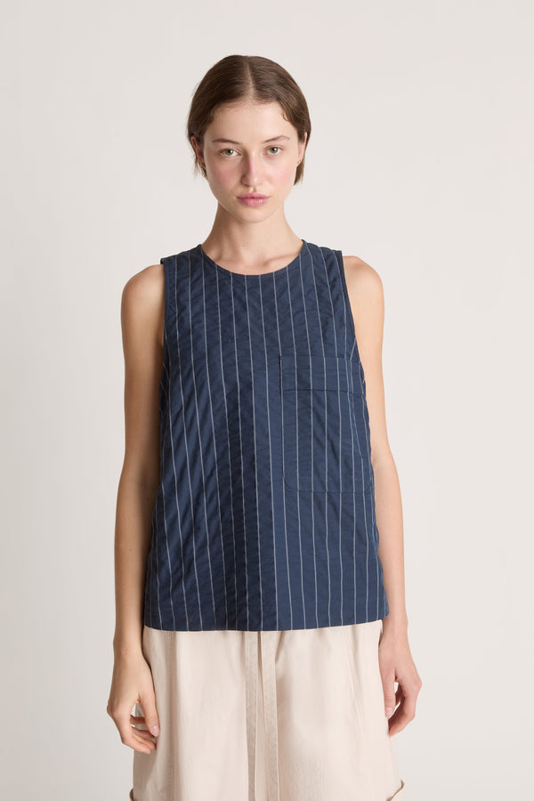 Woman wearing a blue striped dress on a white background