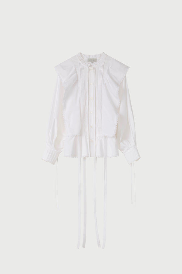 White blouse on a light beige background