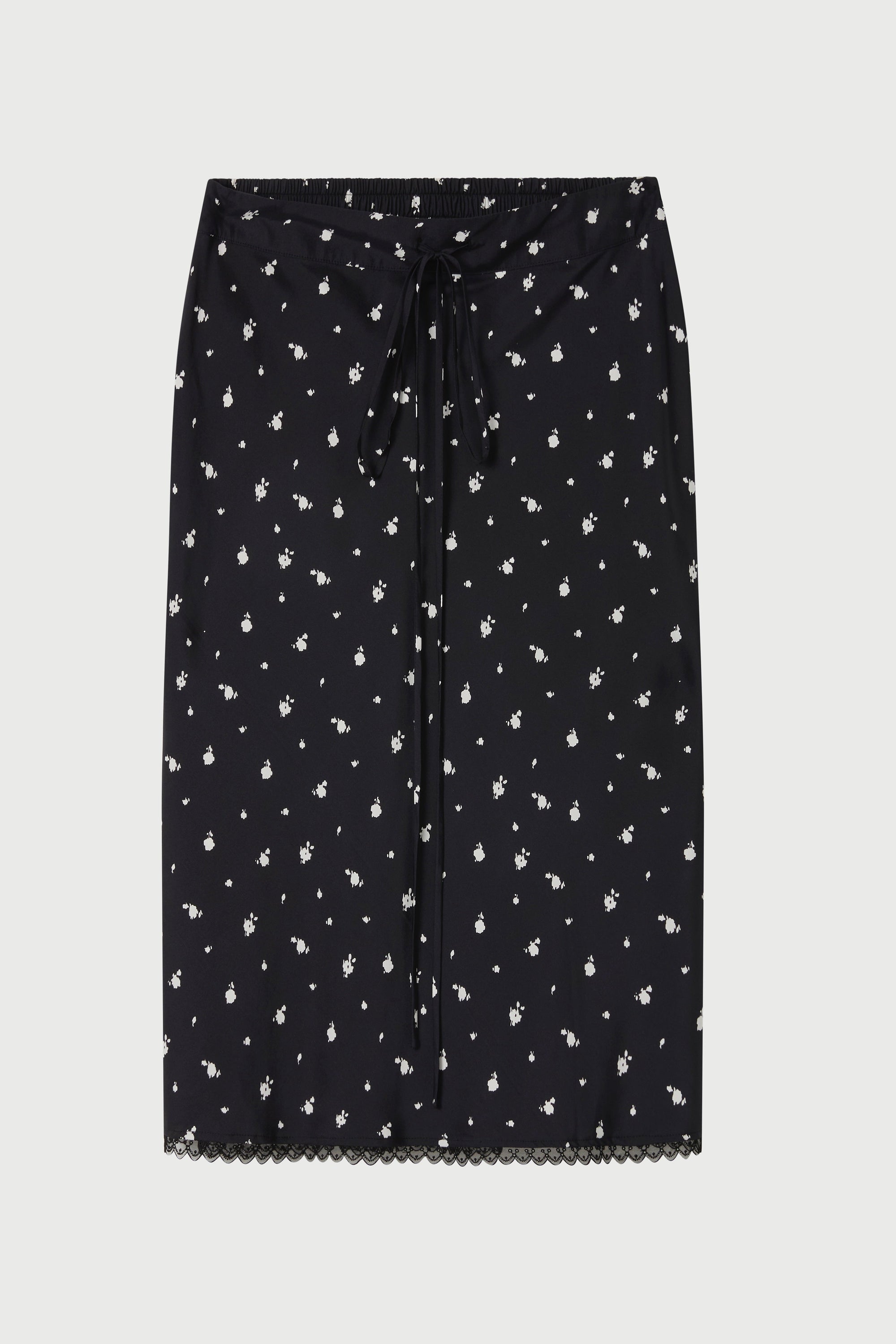 Black skirt with white floral pattern on a light gray background